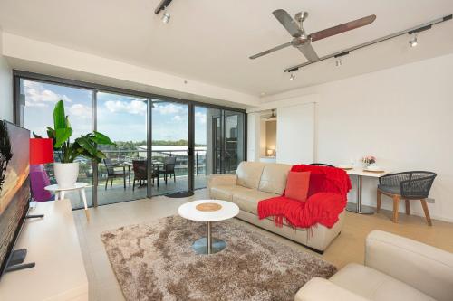 a living room with a couch and a table at Darwin Waterfront Luxury Suites in Darwin