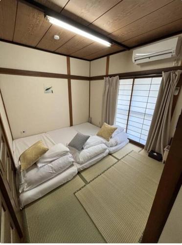 a small room with a bed in the middle at Golden House in Tokyo