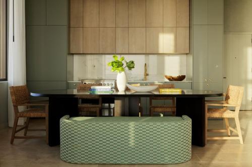 a kitchen with a table with a vase with a plant at Hotel Indigo Grand Cayman by IHG in Grand Cayman