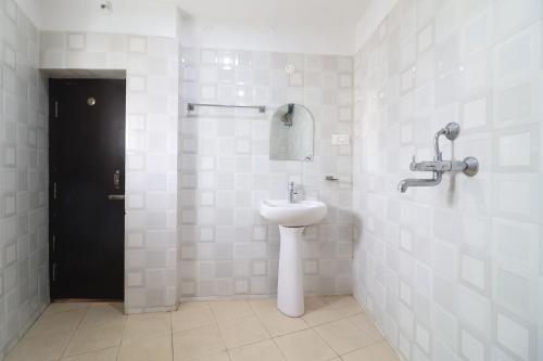 a bathroom with a toilet and a sink in it at FabHotel Shanti International in Rānchī