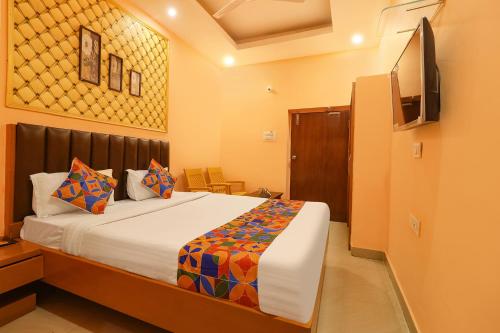 a bedroom with a bed and a television in it at FabHotel Shanti International in Rānchī