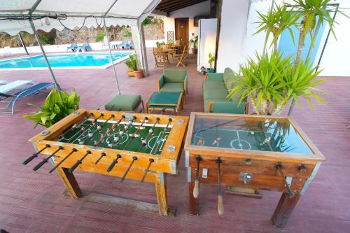 a ping pong table with a board in front of a pool at Casa da Ribeira in Campo Maior
