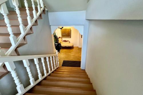 a staircase leading up to a living room at Phuhunsa Boutique Hotel in Nan