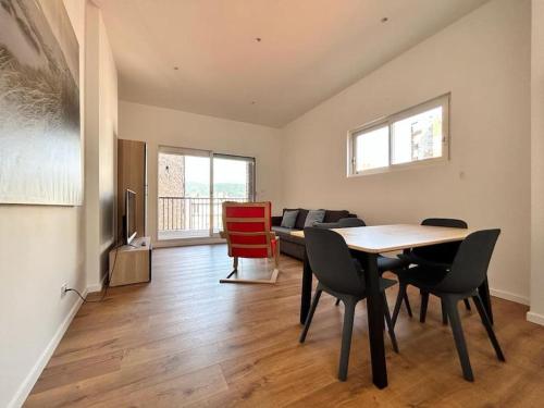 a living room with a table and chairs and a couch at Maison hyper centre maxi 24pers Tour d'Auvergne in Clermont-Ferrand