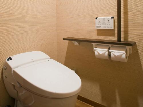 a bathroom with a toilet and two rolls of toilet paper at Kinugawa Onsen Hotel in Nikko