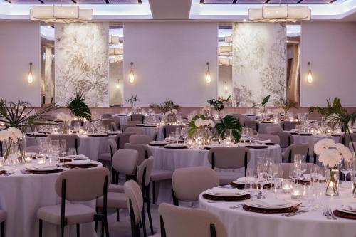 a banquet hall with white tables and chairs at Hotel Indigo Grand Cayman by IHG in Grand Cayman