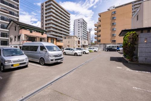 a group of cars parked in a parking lot at Okano Hotel in Sendai