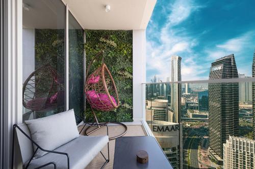 an apartment balcony with a view of the city at Luxury 4BR Burj Khalifa & Fountain Views in Dubai