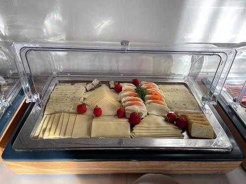 a plastic container filled with sushi in a refrigerator at Hotel Luther Birke Wittenberg in Lutherstadt Wittenberg