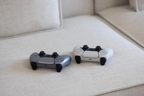two video game controllers sitting on a bed at Luxury 4BR Burj Khalifa & Fountain Views in Dubai