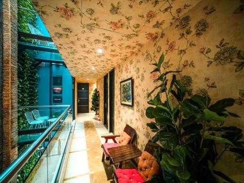 a hallway with a room with flowers on the wall at WoodApple Residency in New Delhi