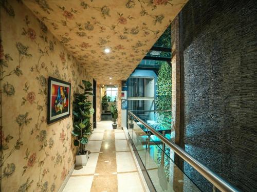 a hallway of a building with flowers on the wall at WoodApple Residency in New Delhi