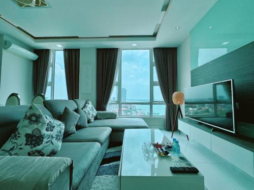 a living room with a couch and a tv at Infinity 28 Hotel and Residence in Phnom Penh