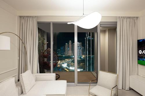 a living room with a view of a city at Luxury 4BR Burj Khalifa & Fountain Views in Dubai
