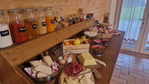 a table with a bunch of different types of food at B&B La Paganina in Borno