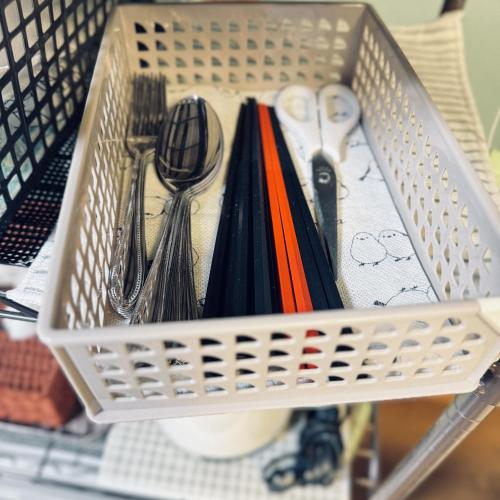 a white basket with utensils on a table at Thanyaporn House in Takayama