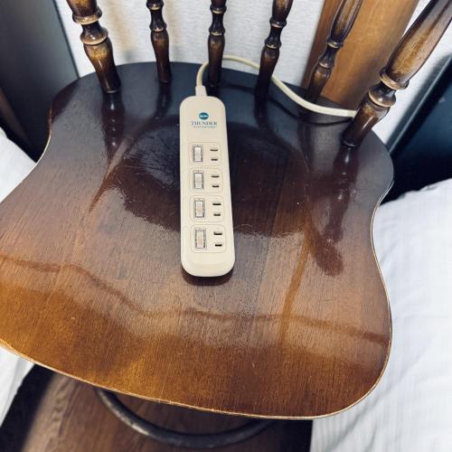 a remote control sitting on top of a guitar at Thanyaporn House in Takayama