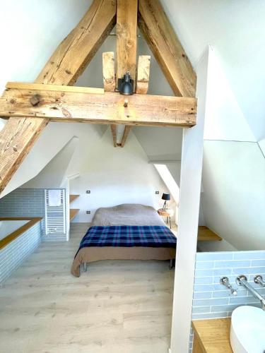 une chambre avec un lit dans un grenier dans l'établissement Villa vue mer panoramique en Baie de somme, à Ault