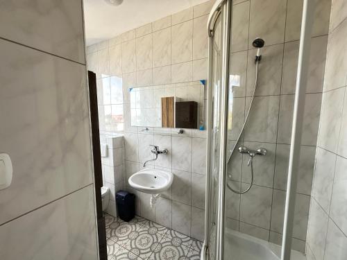a bathroom with a shower and a sink and a toilet at Oceania Mielno in Mielno