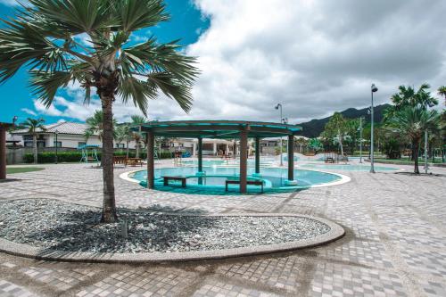 a palm tree and a pavilion in a park at Chii Lih Resort in Luye