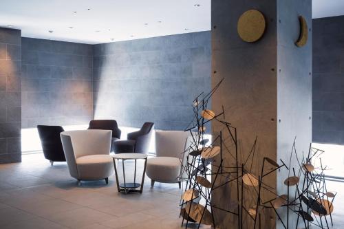 a waiting room with chairs and a table at HAKODATE Uminokaze in Hakodate