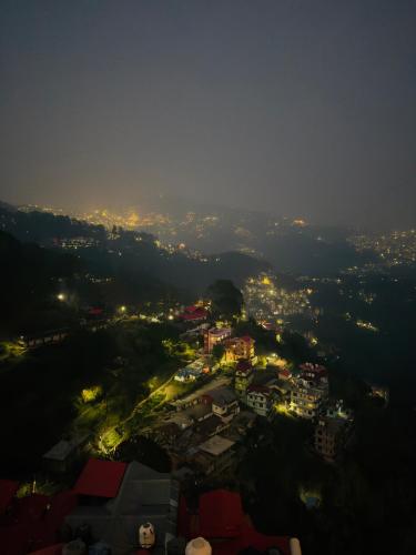 a view of a city at night with lights at Hotel Apple Regency in Shimla
