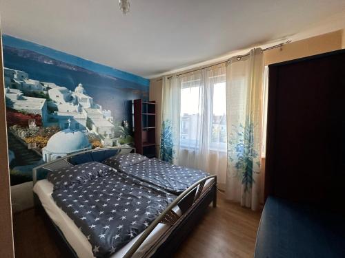 a bedroom with a bed with a mural on the wall at Oceania Mielno in Mielno