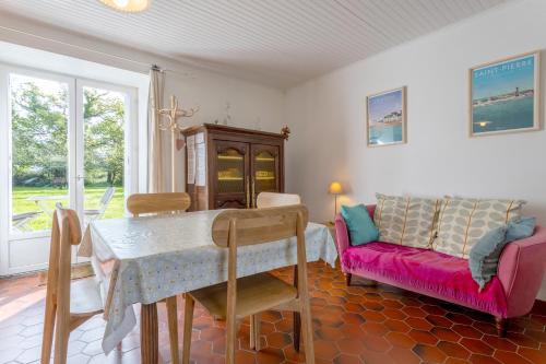 un salon avec une table et un canapé dans l'établissement Hortensias - plage 5min en voiture, à Plobannalec-Lesconil