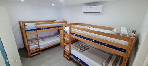 a room with three bunk beds in a room at Riba Fish Neum in Neum