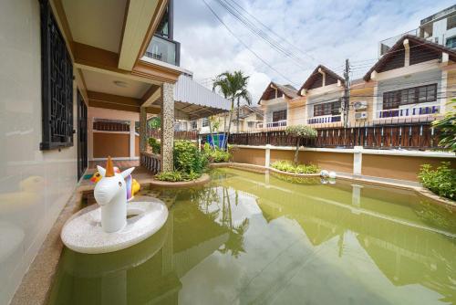 a house with a pool with a toy in the water at Pool Villa at Central Pattaya Near Big C-EXTRA in Pattaya