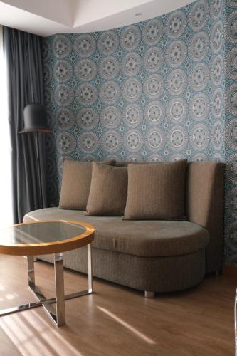 a living room with a couch and a table at Liberty Kuşadası in Kusadası