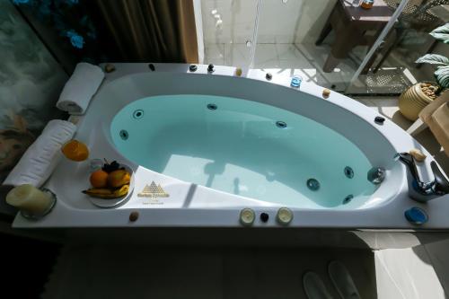 a blue bath tub sitting in a bathroom at Horizon Pyramids View inn in Cairo