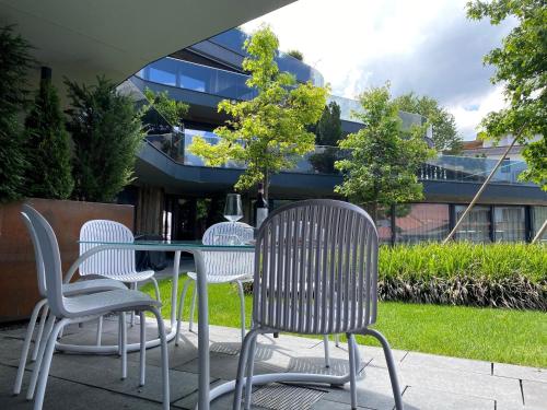 a table and chairs sitting in front of a building at Mountain Chalet Kirchberg by Apartment Managers in Kirchberg in Tirol