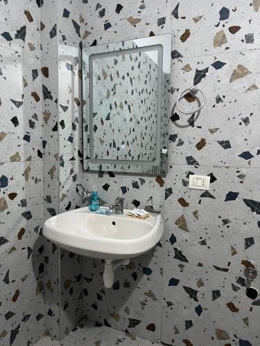a bathroom with a sink and a mirror at Doris Apartments in Himare