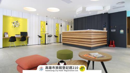 a lobby with a desk and a table and chairs at Blue Coast Hotel in Kaohsiung