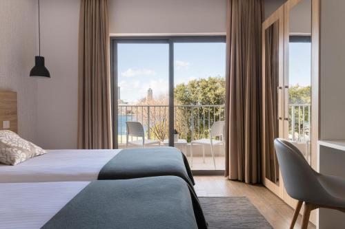 a hotel room with a bed and a balcony at Plaza Regency Hotels in Sliema