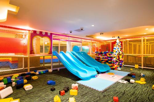 a play room with a slide and a christmas tree at Chii Lih Resort in Luye