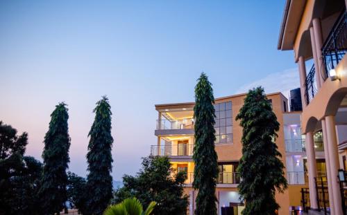 a row of trees in front of a building at Precious Villas Lubowa in Kampala