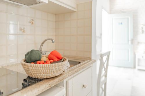 a basket of vegetables sitting on a counter in a kitchen at Agia Anna Living in Agia Anna Naxos