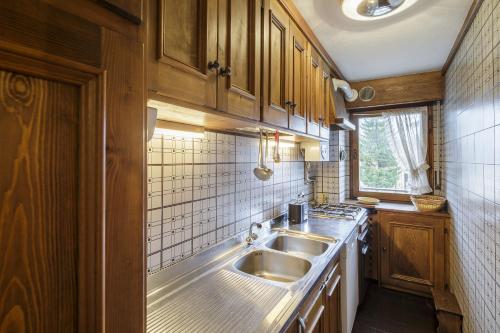 a kitchen with a sink and a counter top at Villa Riadezeto - Stayincortina in Cortina dʼAmpezzo