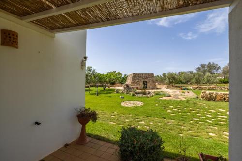a view from the porch of a house with a yard at Aura Solis B&B in Leuca
