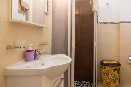 a bathroom with a sink and a shower at Aura Solis B&B in Leuca