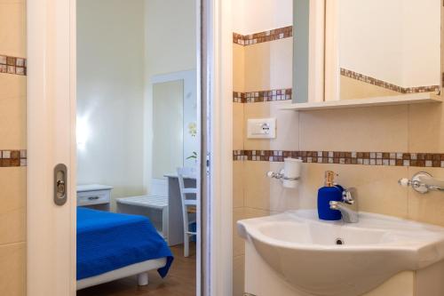 a bathroom with a sink and a mirror at Aura Solis B&B in Leuca