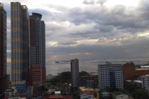 a view of a city with tall buildings at COMFY 1-BR Condo near SLEC, US Embassy, Malls,Park in Manila