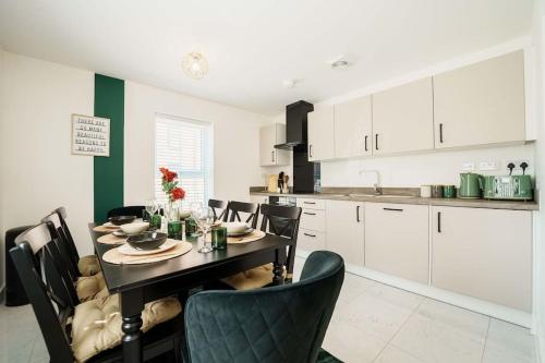 a dining room with a table and chairs in a kitchen at Superb 4BR New House in Leeds