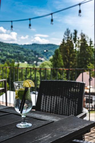 a wine glass sitting on a wooden table with a view at Willa Amelia in Solina