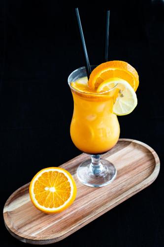 a glass of orange juice and a slice of orange at Willa Amelia in Solina