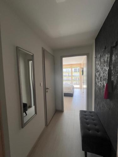 a room with a hallway with a mirror and a bed at Ale Apartman Siófok in Siófok