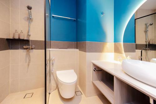 a bathroom with a toilet and a sink at Coliwoo Hotel Pasir Panjang - CoLiving in Singapore