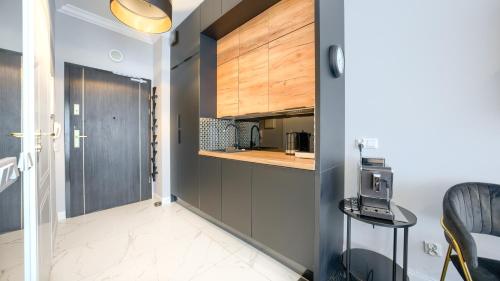 a kitchen with gray cabinets and a counter top at Lividus, Sun & Snow in Świnoujście